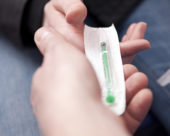 Passing a syringe to a drug recovery patient