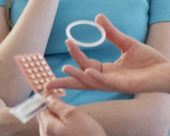 A doctor showing contraception methods to a young woman